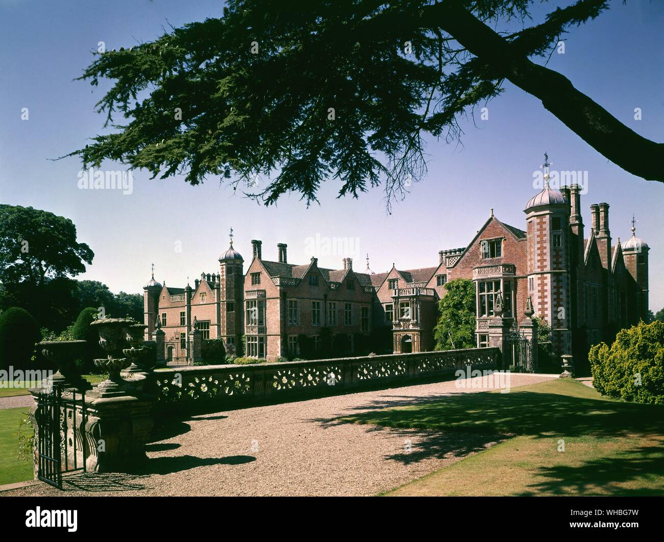 Charlcote Park, Warwicks. - both historically and architecturally significant, and is still inhabited by descendants of the Lucy family. The present house, was undertaken by Thomas Lucy (later to become Sir Thomas Lucy). Building commenced in 1551, and the east front still retains much of its Elizabethan form, with gables and octagonal corner turrets, each with their own cupola, ball and weathervane. However, most of the external décor dates from the 19th century when George Hammond Lucy inherited Charlecote Park and wished to restore the house to its former glory.. Stock Photo