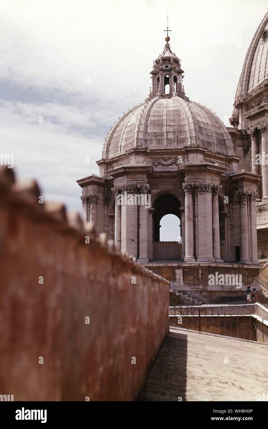 The dome and a cupola from the roof by day at St. Peter's in Rome.. Stock Photo