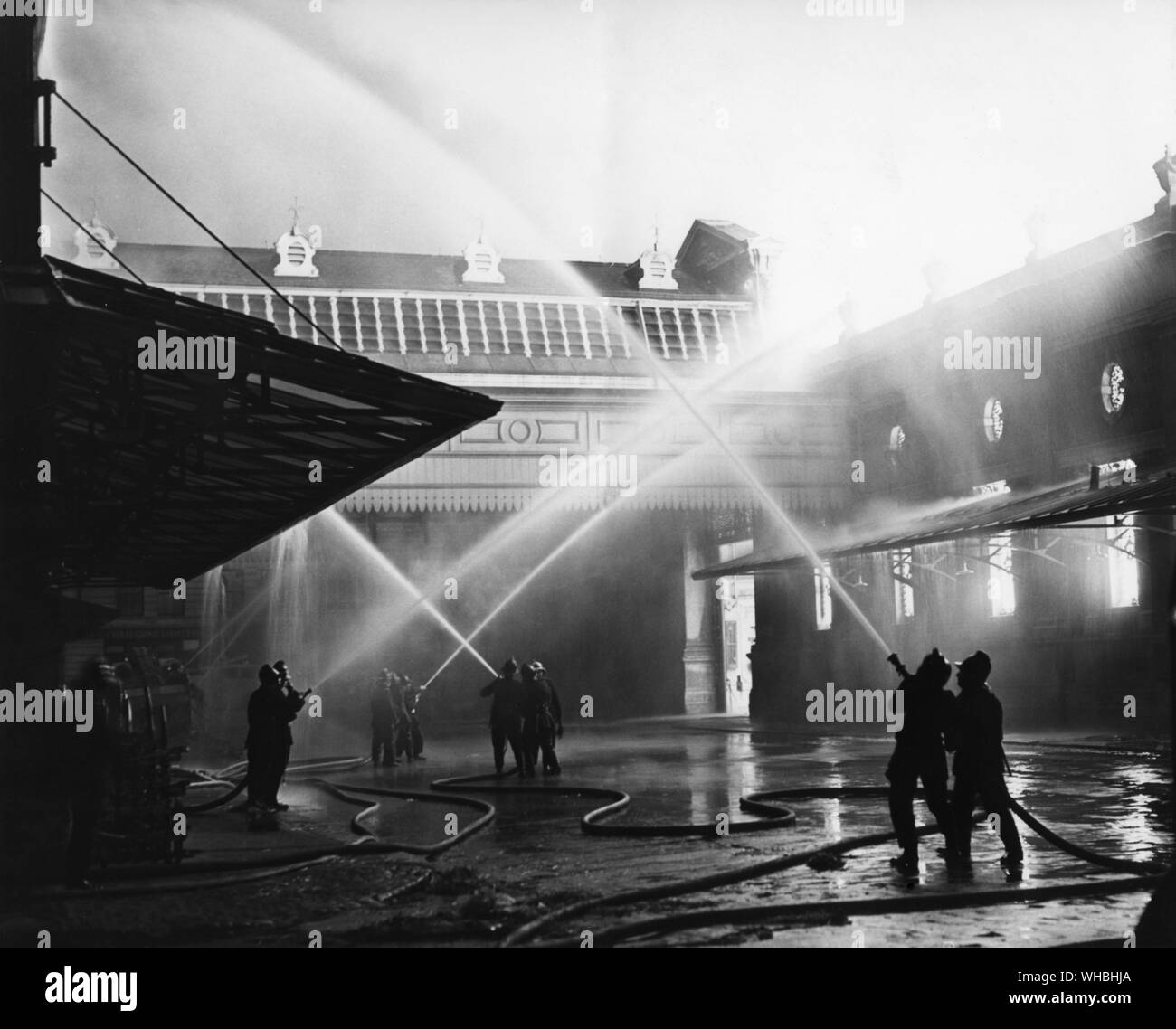 The Smithfield Fire. . Firemen lay hoses on to the East Wall. . Scene at Smithfield after the fire. . 1958 Stock Photo