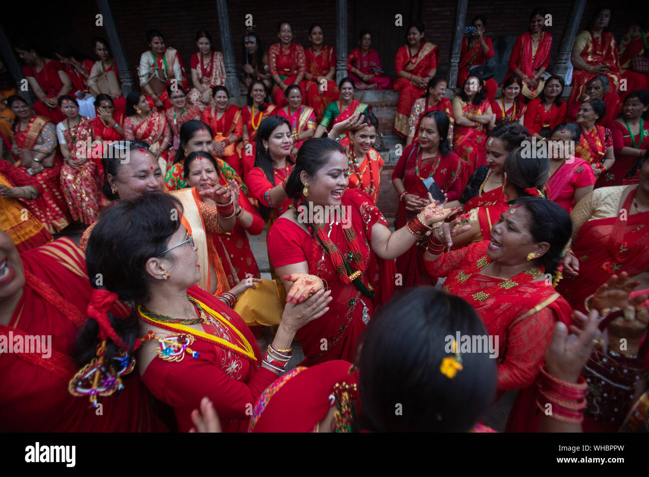 Kathmandu, Nepal. 02nd Sep, 2019. Neplese Hindu Women sing and dance at the premises of Pashupatinath Temple during the Teej festival in Kathmandu, Nepal on Monday 2 September, 2019. During this festival, Hindu women observe a day-long fast and pray for their husbands and for a happy married life. Those who are unmarried pray for a good husband. (Photo by Prabin Ranabhat/Pacific Press) Credit: Pacific Press Agency/Alamy Live News Stock Photo