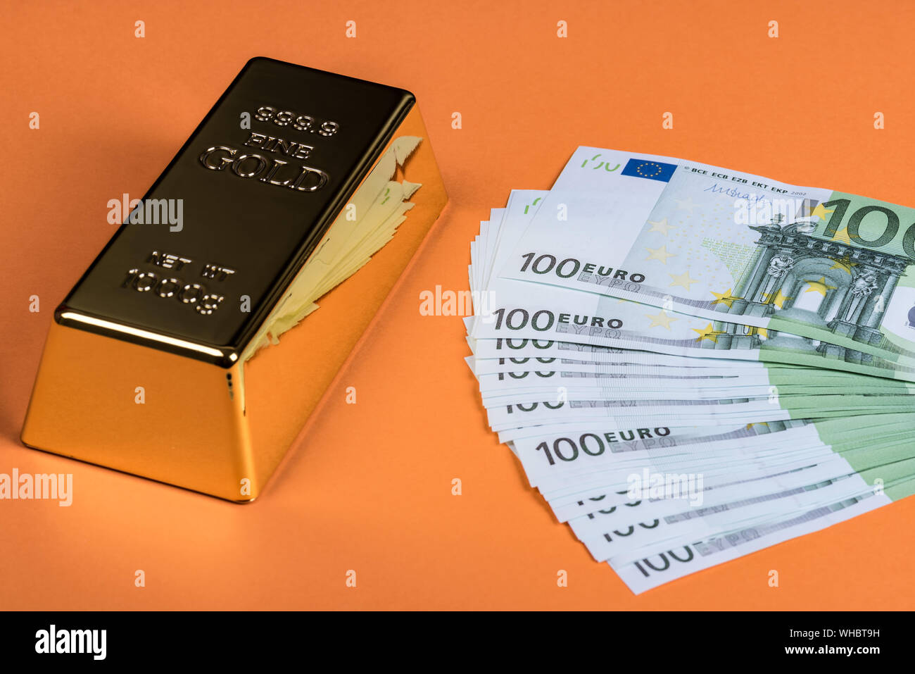Euro cash and gold bar on a orange background. Banknotes. Money. Bill
