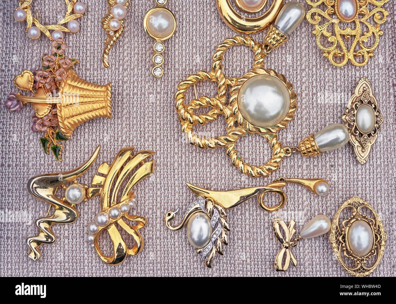 Brooches with pearls on a beige background. Jewelry background for