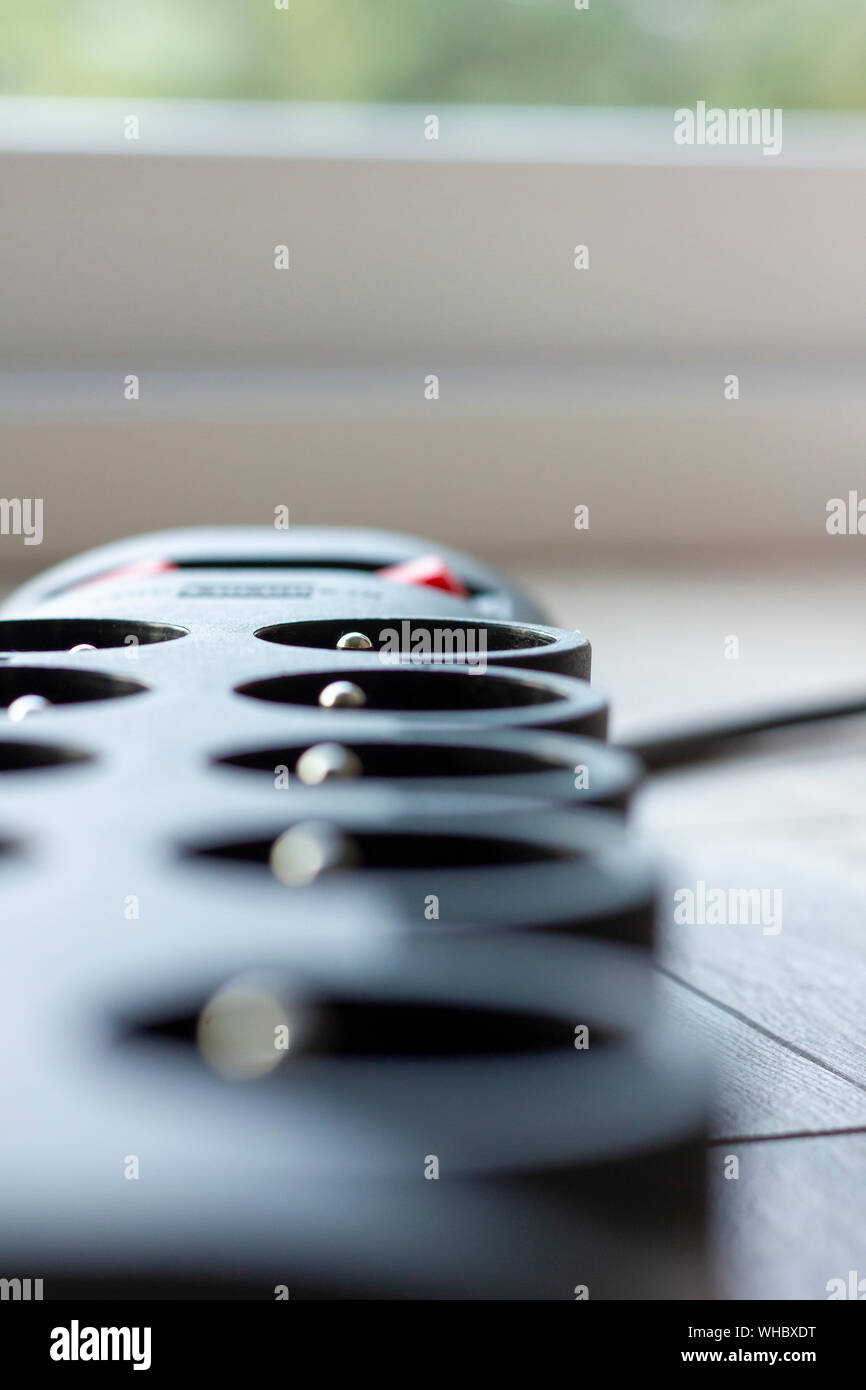 A close up portrait of an electric plug system with a switch to turn