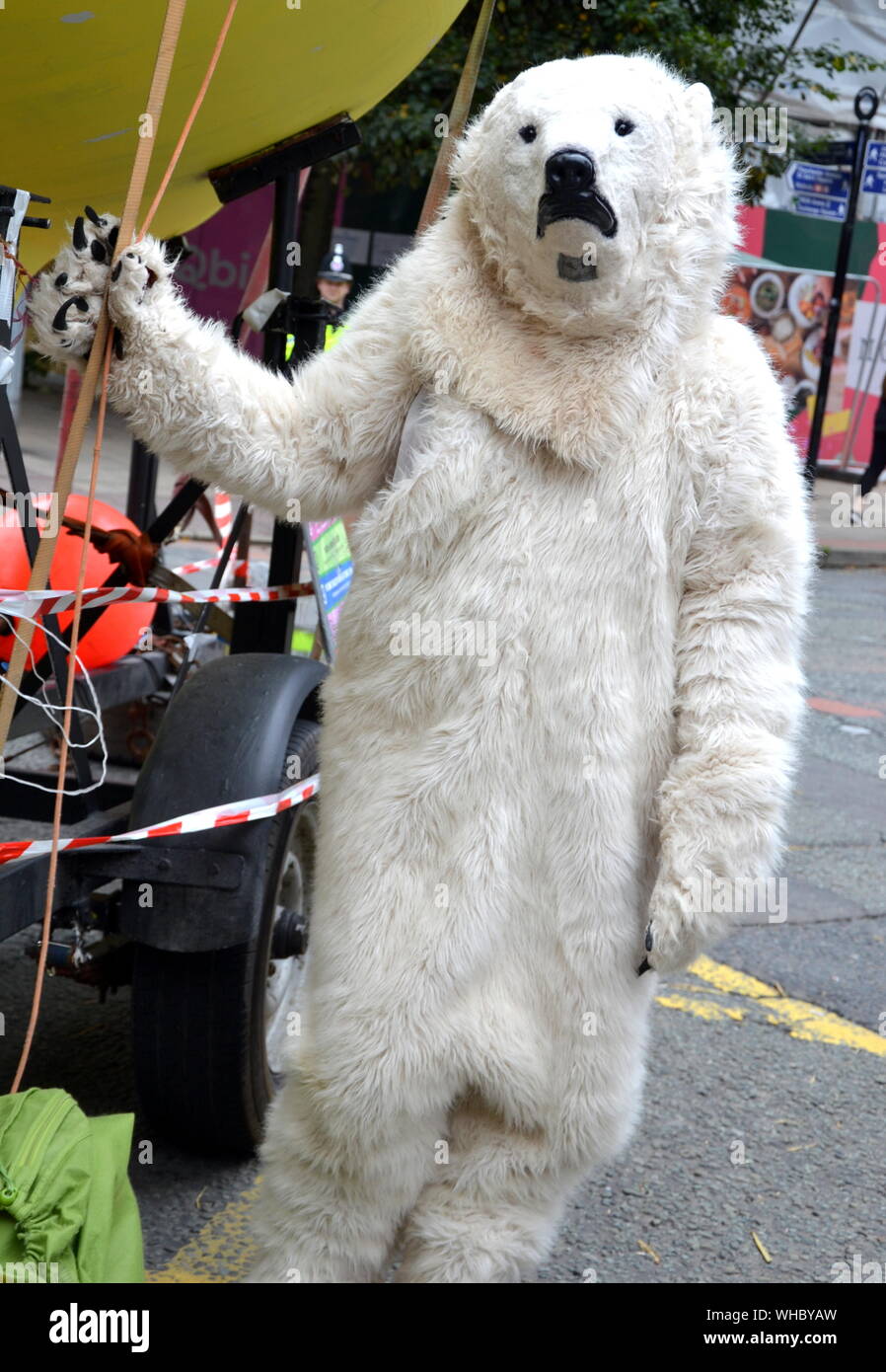A person in a polar bear suit on Deansgate as Northern Rebellion protesters, part of the global movement Extinction Rebellion, marched through Manchester, uk, and held a series of die-ins to urge for action on climate change on September 2nd, 2019. Protest sites included Barclays Bank, a Primark store and HSBC Bank. This was the fourth day of a protest which blocked Deansgate, a main road in central Manchester. Stock Photo