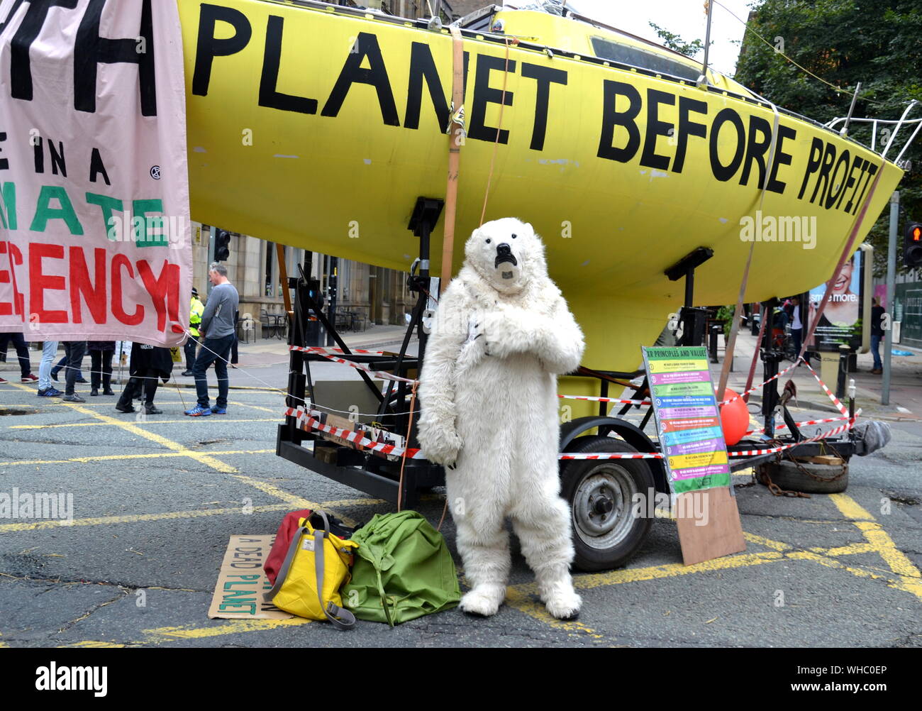 A person in a polar bear suit on Deansgate as Northern Rebellion protesters, part of the global movement Extinction Rebellion, marched through Manchester, uk, and held a series of die-ins to urge for action on climate change on September 2nd, 2019. Protest sites included Barclays Bank, a Primark store and HSBC Bank. This was the fourth day of a protest which blocked Deansgate, a main road in central Manchester. Stock Photo