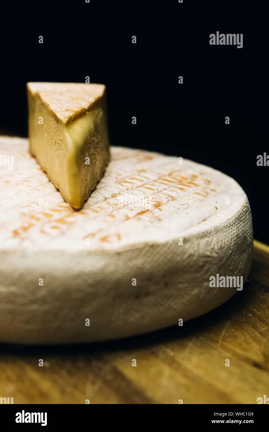 Detail of the French Le Marcaire cheese on the wooden table Stock Photo