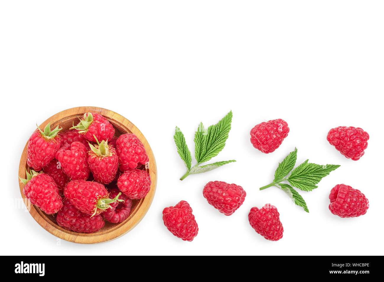 Raspberry Flat Lay raspberries in wooden bowl with leaves isolated on white background ...