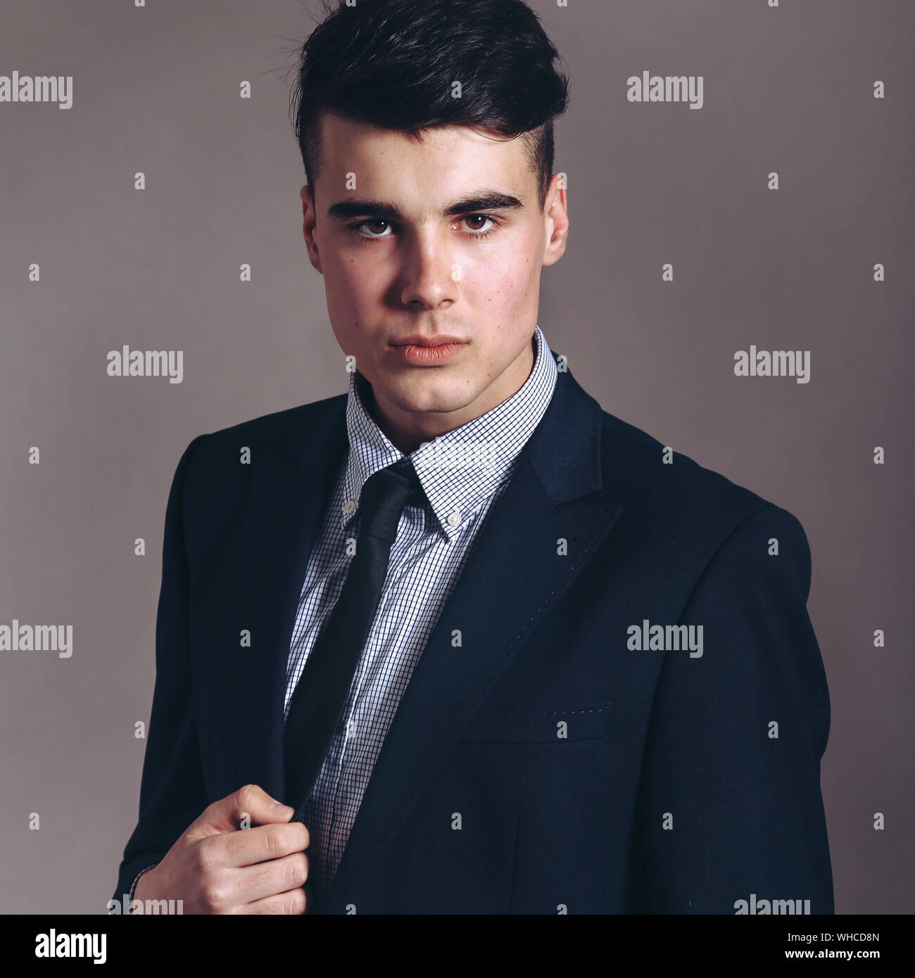 Portrait of handsome stylish man in elegant black suit Stock Photo - Alamy