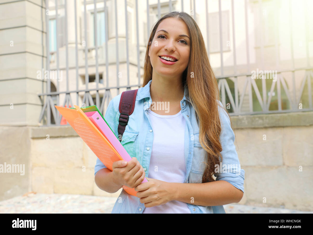Happy student girl looking in front of her outdoors. Stock Photo
