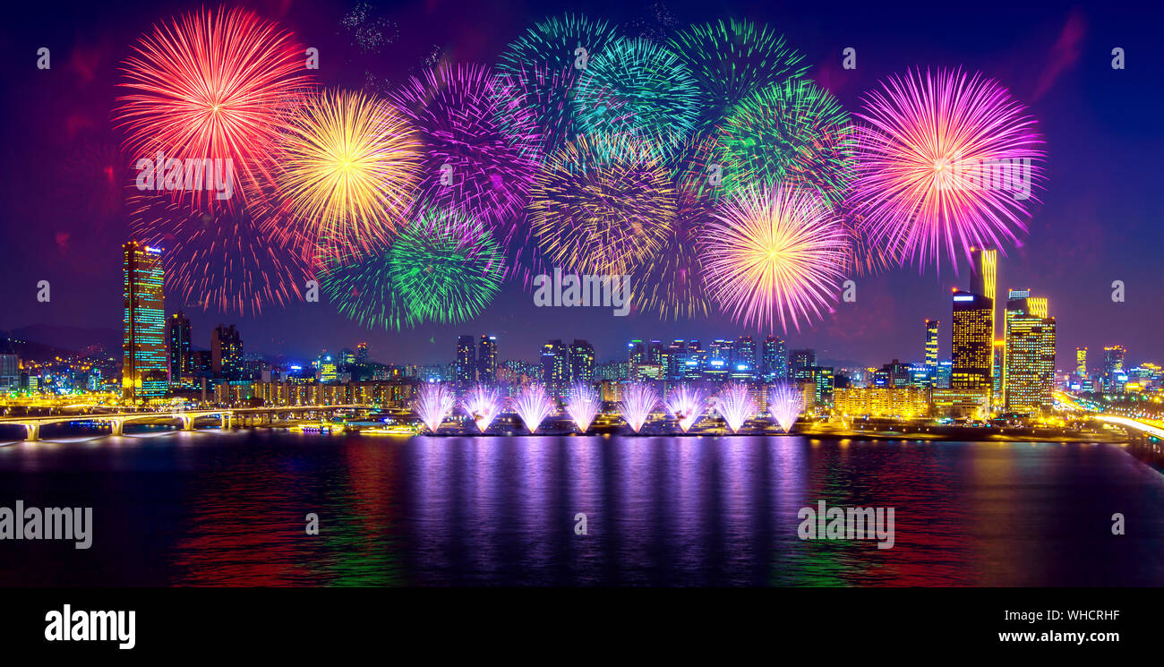 Low Angle View Of Firework Display Over River In City Stock Photo