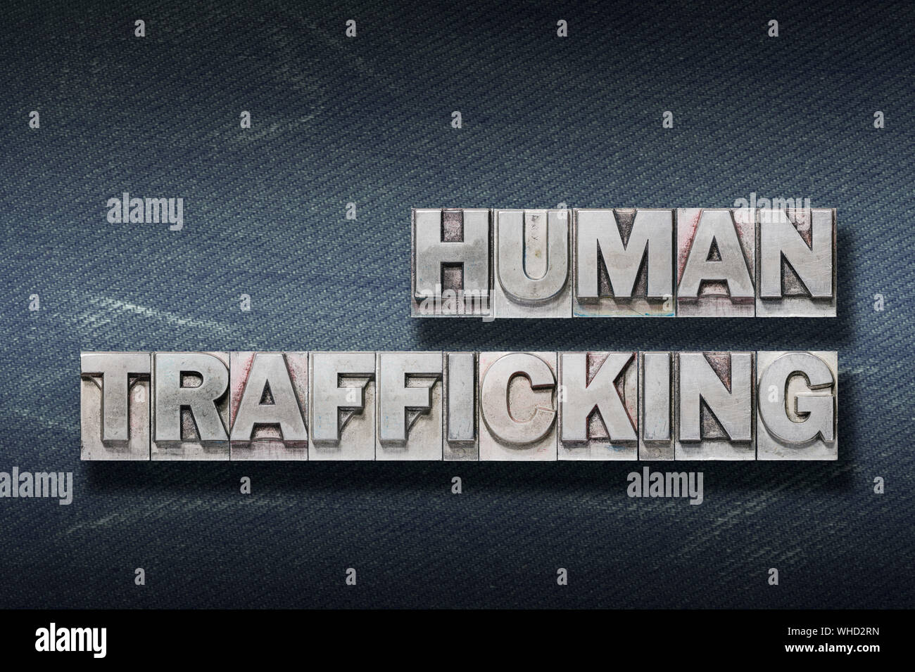 human trafficking phrase made from metallic letterpress on dark jeans ...
