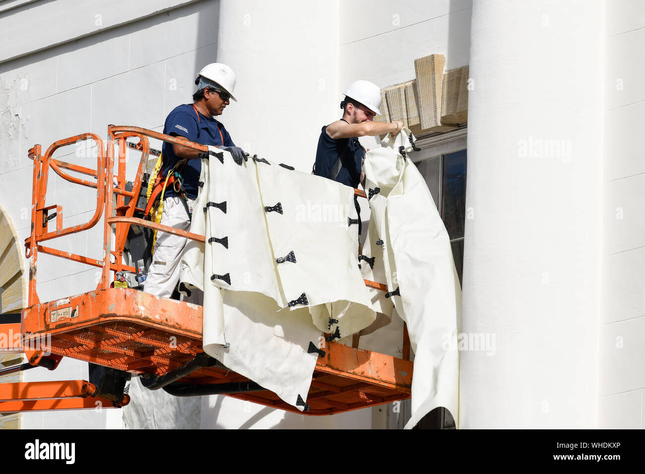 Charleston, South Carolina, USA. 02nd Sep, 2019. Workers attach hurricane cloth to the historic Federal Court House in preparation for Hurricane Dorian on Monday, September 2, 2019 in Charleston, South Carolina. The monster Category 5 storm devastated the Bahamas and is expected to weaken and then move north along the Eastern Seaboard.  Photo by Richard Ellis/UPI Credit: UPI/Alamy Live News Stock Photo