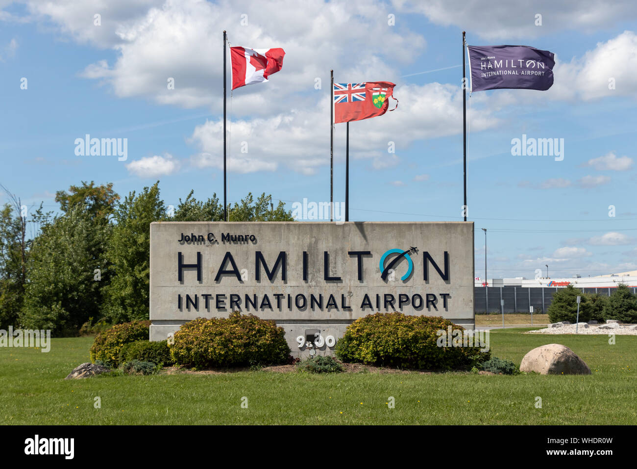 Sign at the entrance to John C. Munro Hamilton International Airport on a sunny day. Stock Photo