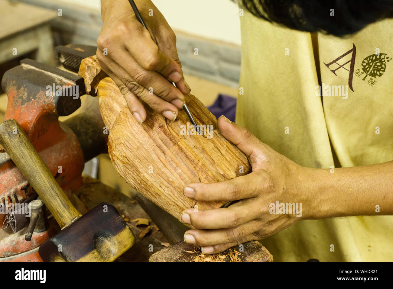 a sculptor of the Cambodian company of Angkor craftsmen cuts a Buddha's