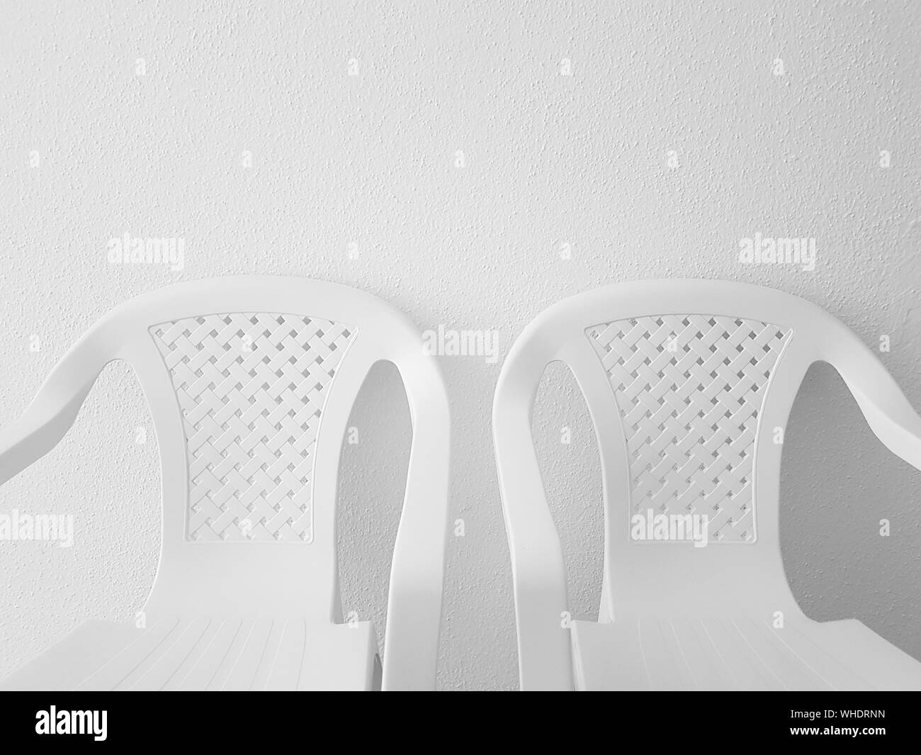 Empty Chairs By Wall Stock Photo Alamy