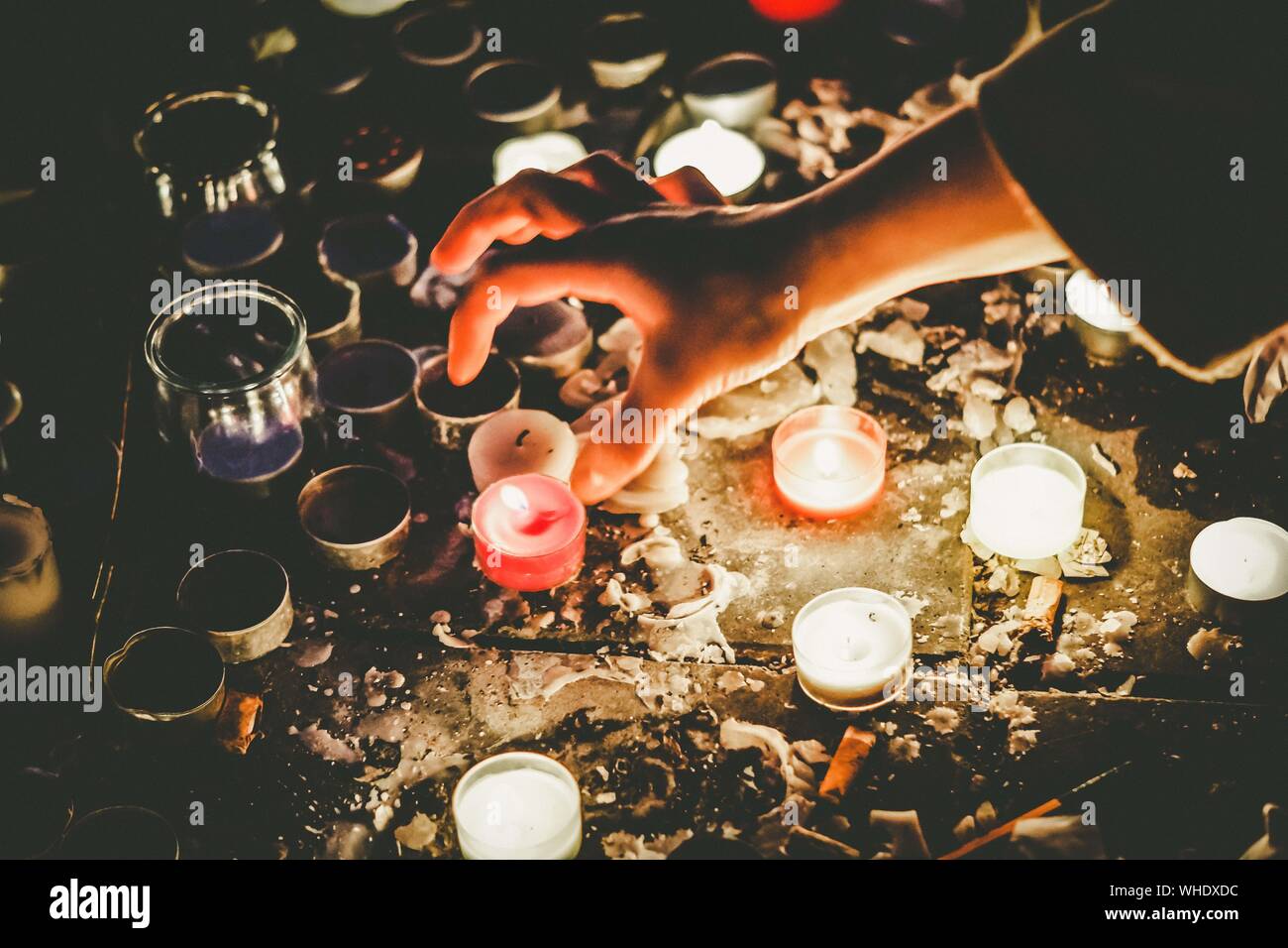 Person Placing Tea Light Candles Lit As Religious Belief Stock Photo