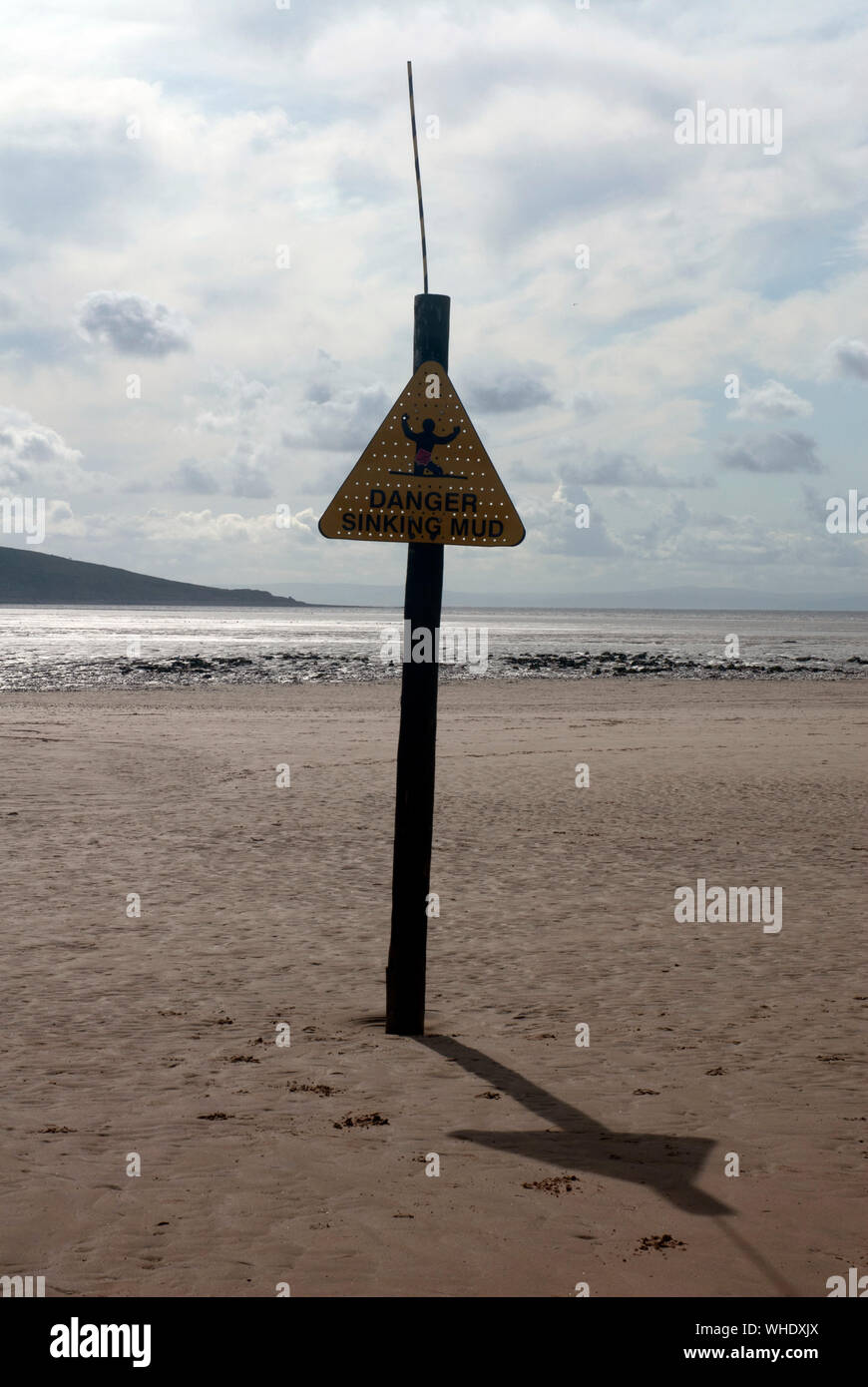 Warning sign about the danger of sinking sands on the mudflats at