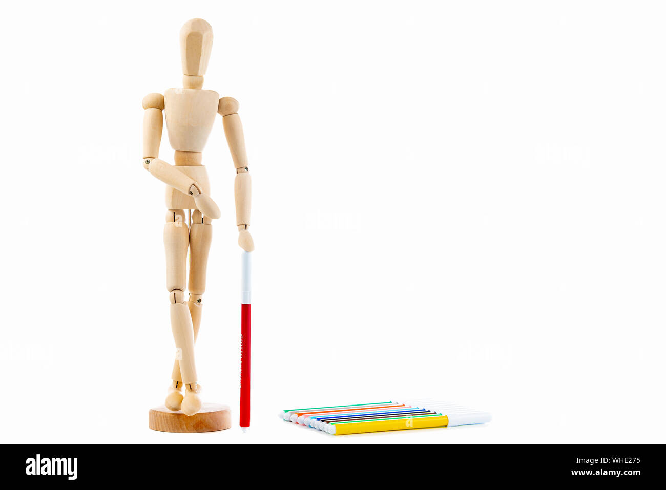 Small wood mannequin with Colorful markers on a white background Stock Photo