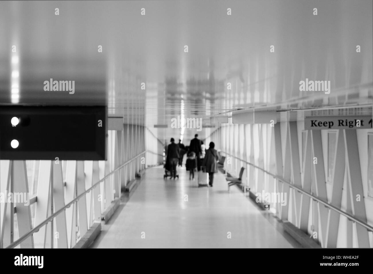 People Walking In Passage Of Stansted Airport Stock Photo