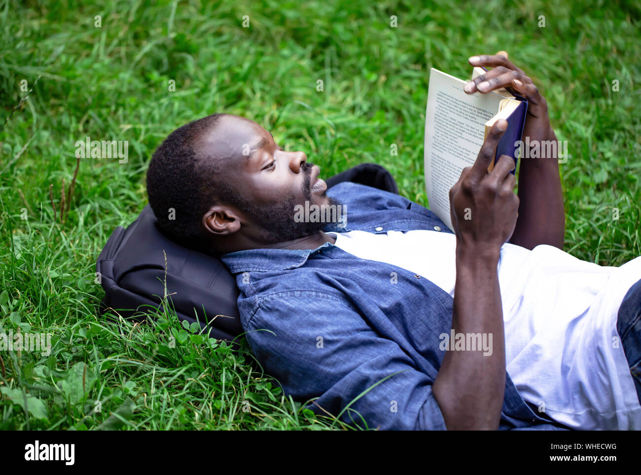 Black concentrated student guy preparing for exam outdoors Stock Photo