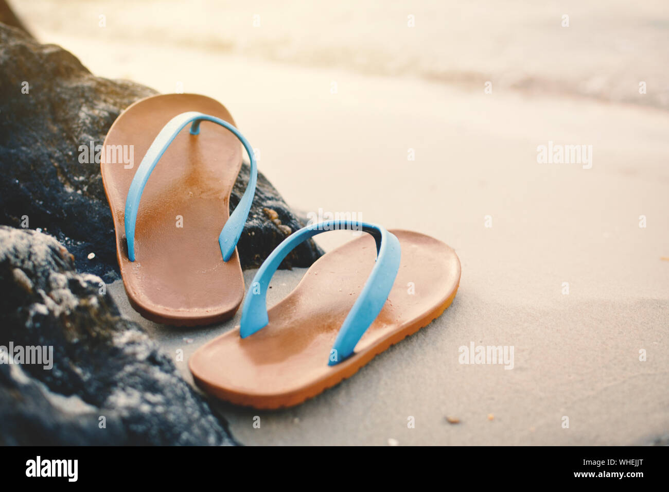 Close-up View Of Flip-flop On Sand At Beach Stock Photo