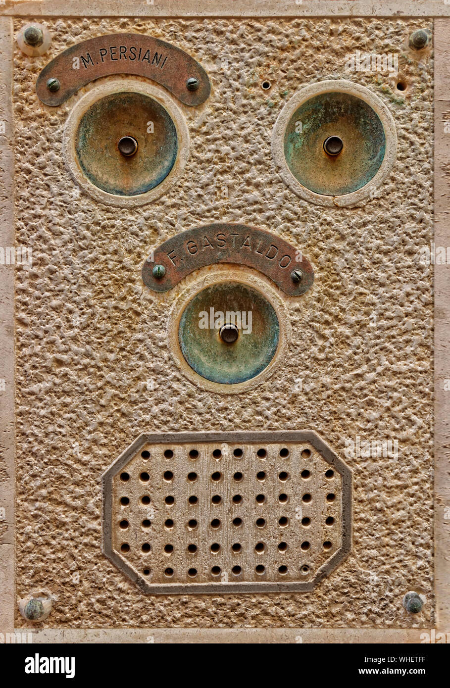 Bell push and intercom facia with face-like appearance from an apartment block in Venice, Italy. Stock Photo