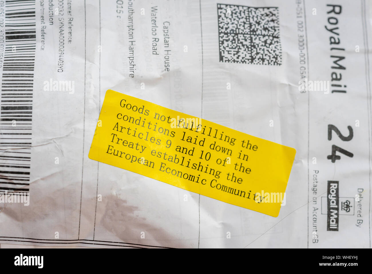 Yellow sticker on a parcel arriving from outside the European Economic Community (EEC) meaning the product might be subject to a customs fee/ duty, UK Stock Photo