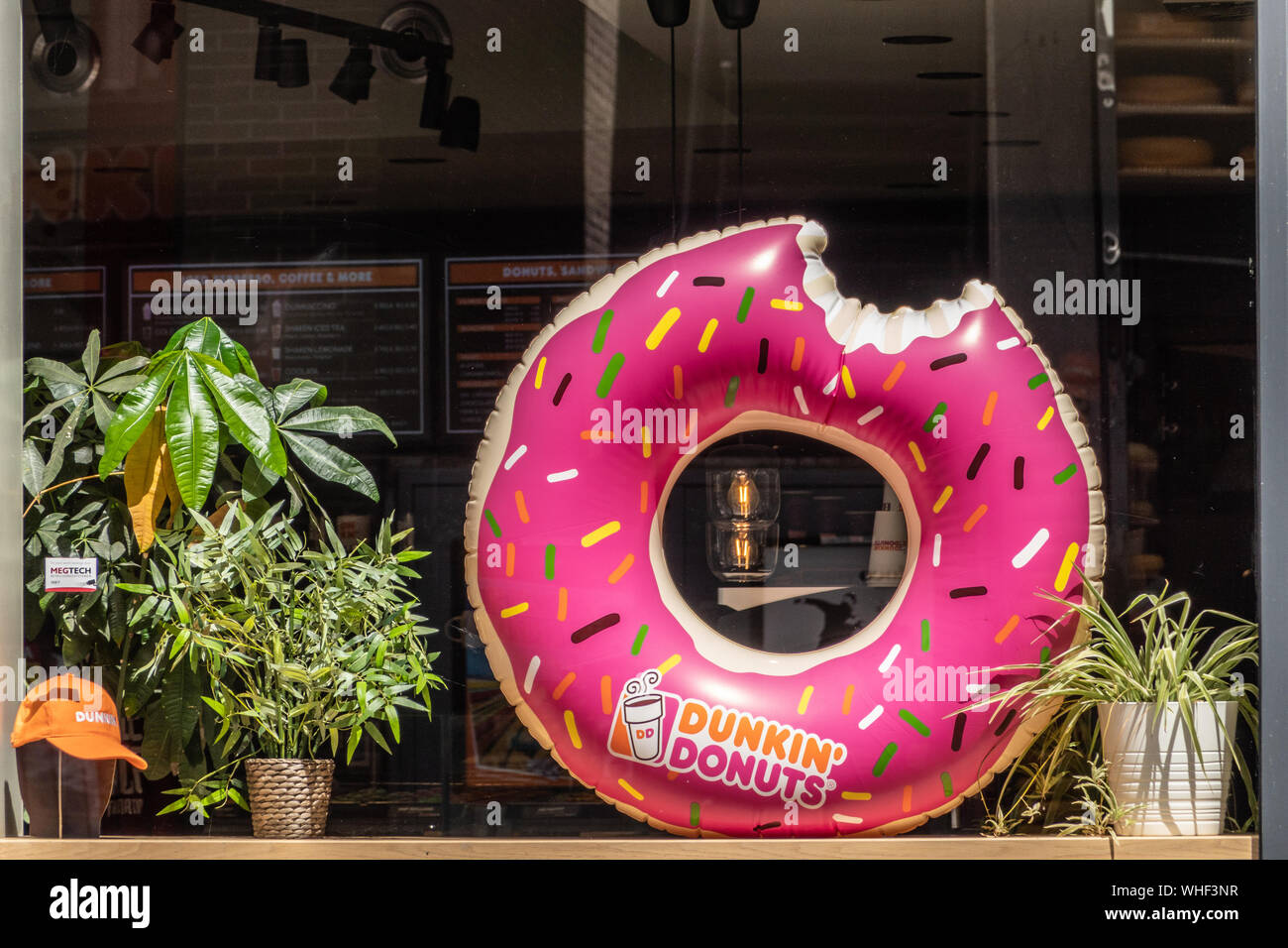 Amsterdam, the Netherlands - July 1, 2019: Giant blown-up image of pink Dunkin’Donuts image in window of shop with same name. Stock Photo