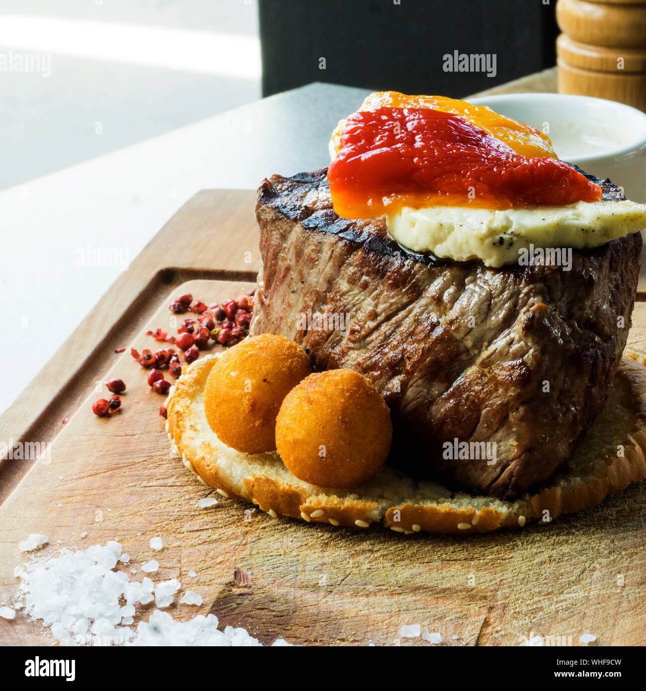 Close-up Of Fresh Filet Mignon Steak With Brynza And Mushroom Sauce On Wooden Cutting Board Stock Photo