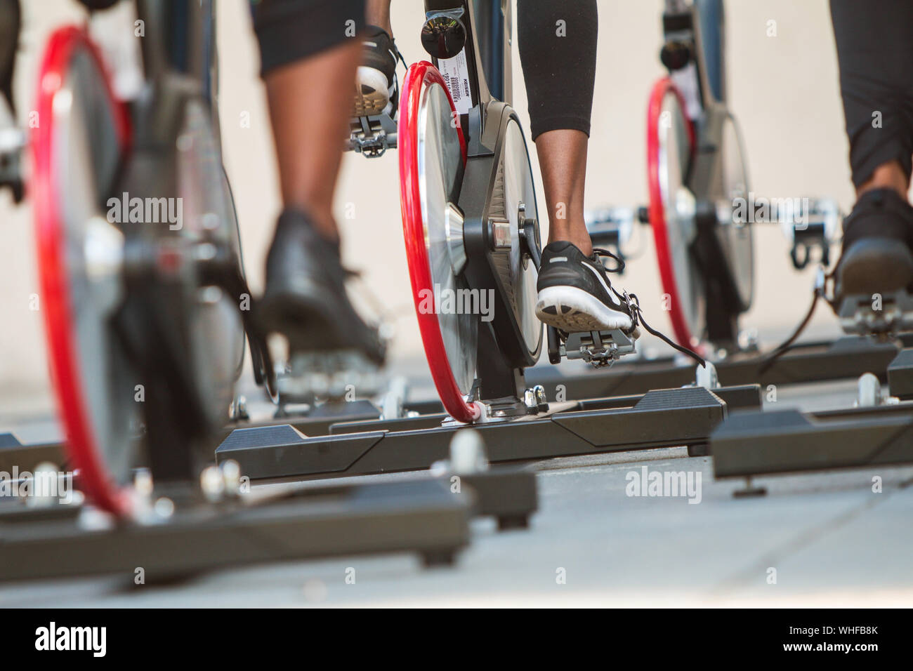 Closeup of women's sneakers pedaling as they participate in an outdoor spin class at the Pretty Girl Sweat Fest in Atlanta on September 15, 2018. Stock Photo