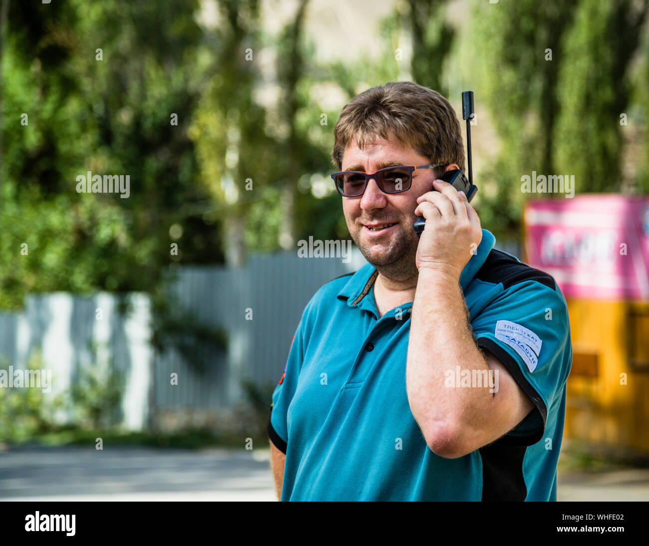 Man Calling with Satellite Telephone, Khorugh, Tajikistan Stock Photo