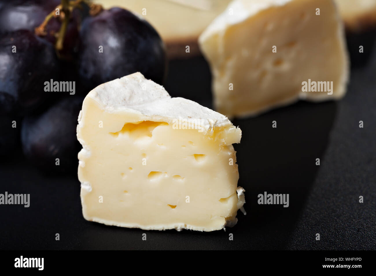 closeup of swiss cheese with grapes and wine Stock Photo Alamy
