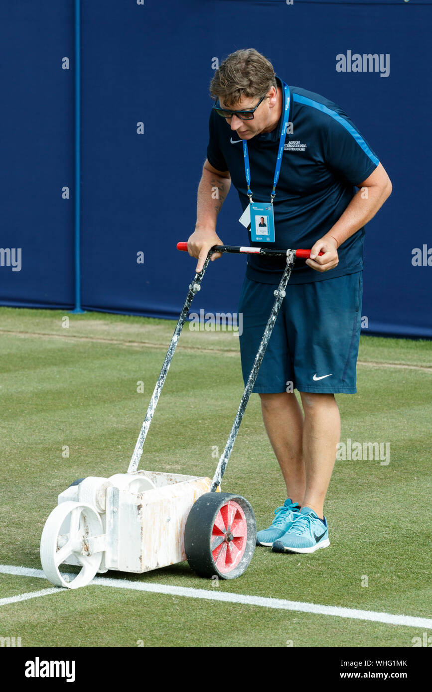 Ground-staff marking tennis court lines at Aegon International 2017- Eastbourne - England.   Monday, 26, June.  Photo Credit: Nick Walker/Sport Pictur Stock Photo