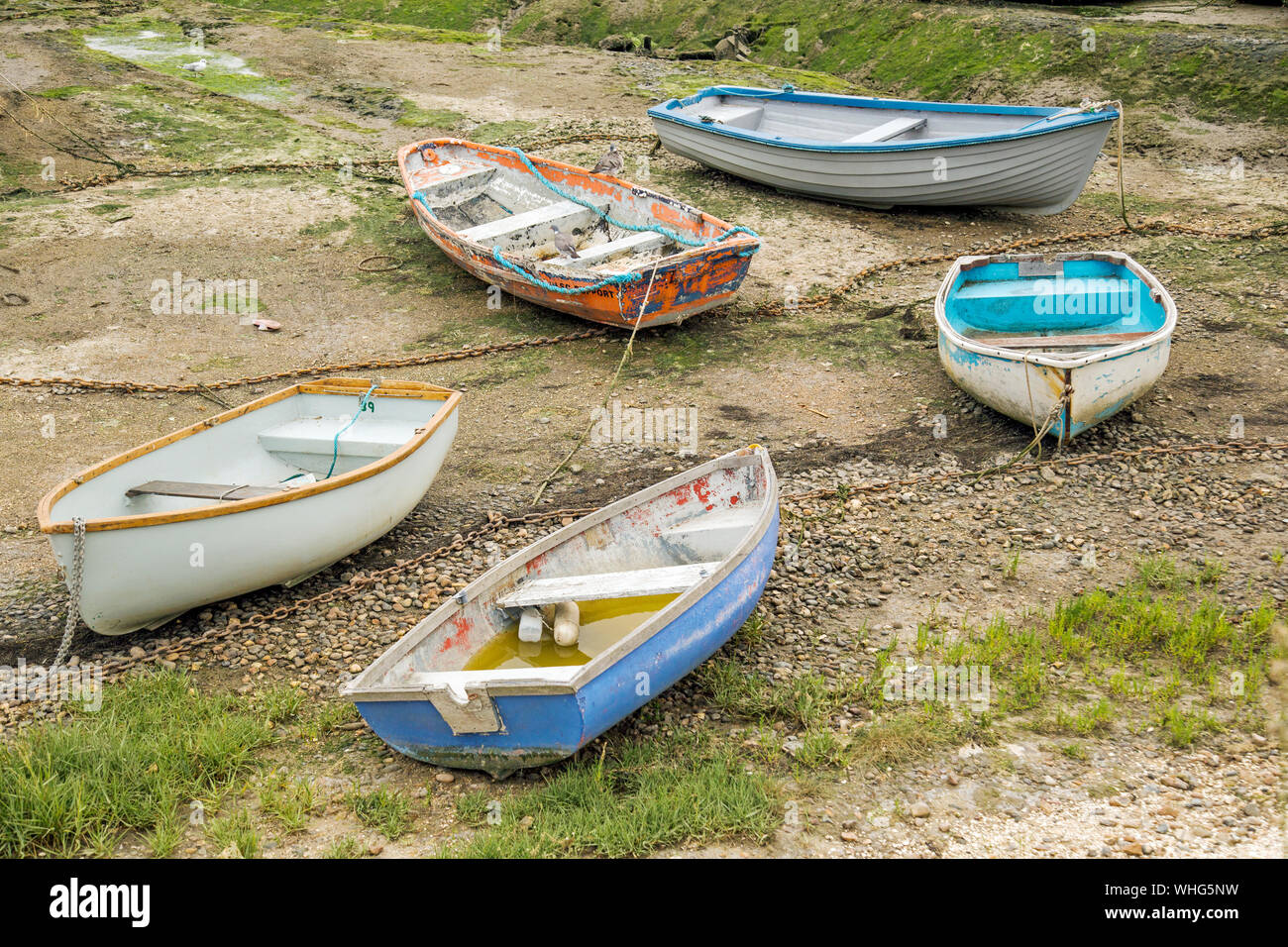 Five small rowing boats laying on the beach Stock Photo