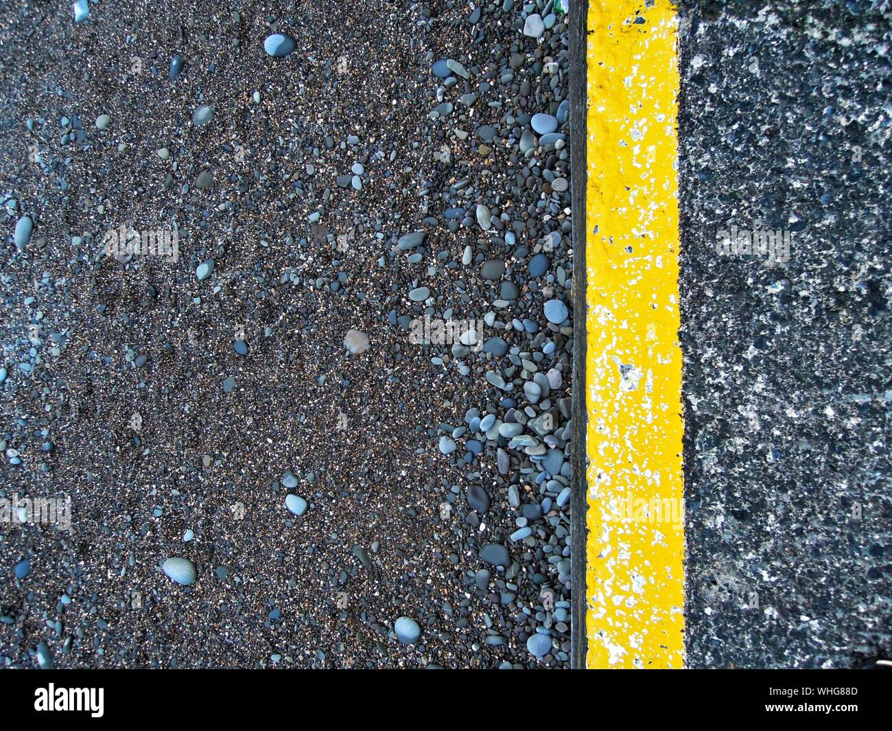 Download High Angle View Of Yellow Marking And Pebbles On Road Stock Photo Alamy Yellowimages Mockups