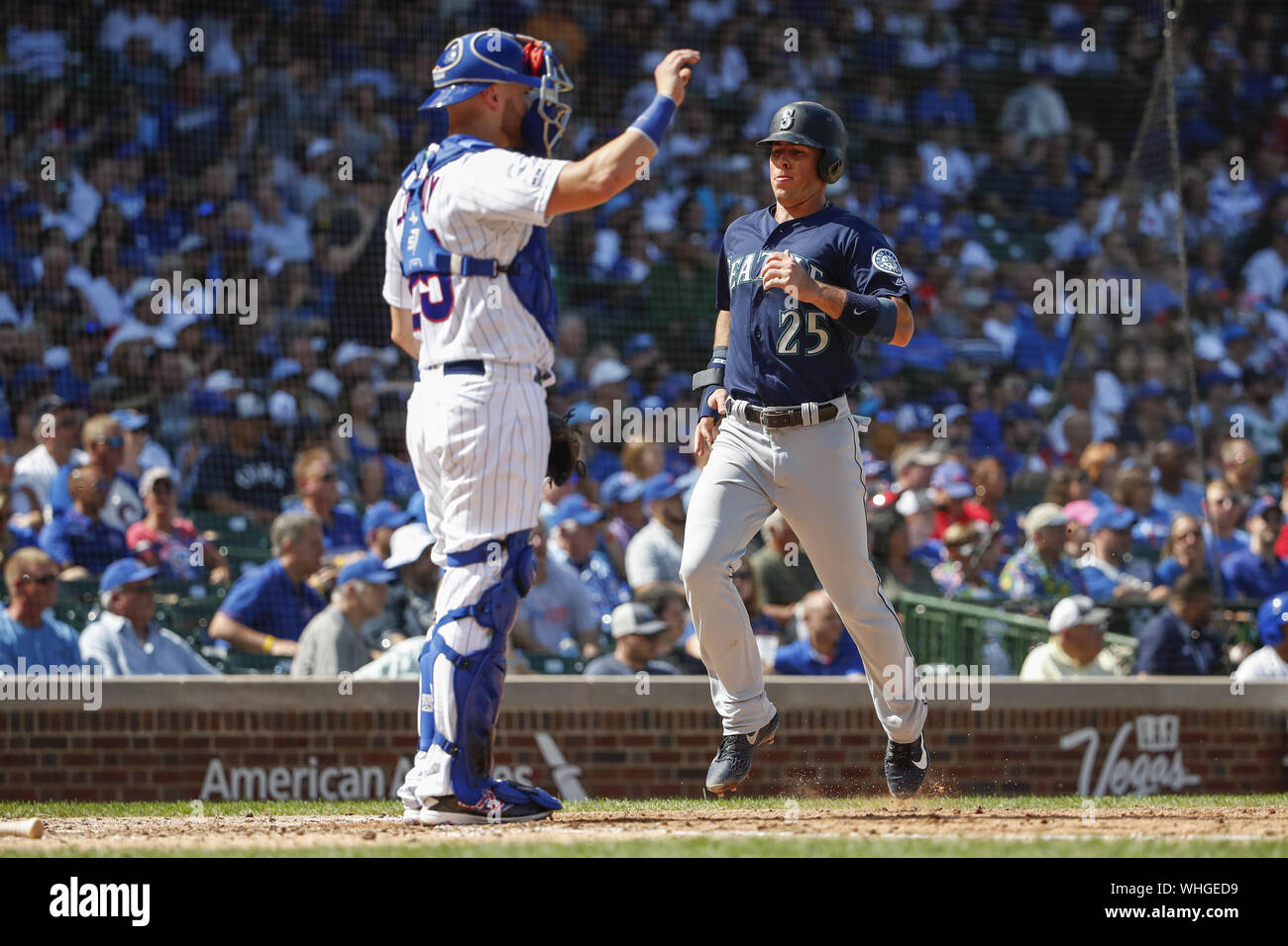 Chicago, USA. 02nd Sep, 2019. Seattle Mariners shortstop Dylan Moore (R) scores past Chicago Cubs catcher Jonathan Lucroy (L) on a double hit by second baseman Dee Gordon in the fifth inning at Wrigley Field on Monday, September 2, 2019 in Chicago. Photo by Kamil Krzaczynski/UPI Credit: UPI/Alamy Live News Stock Photo