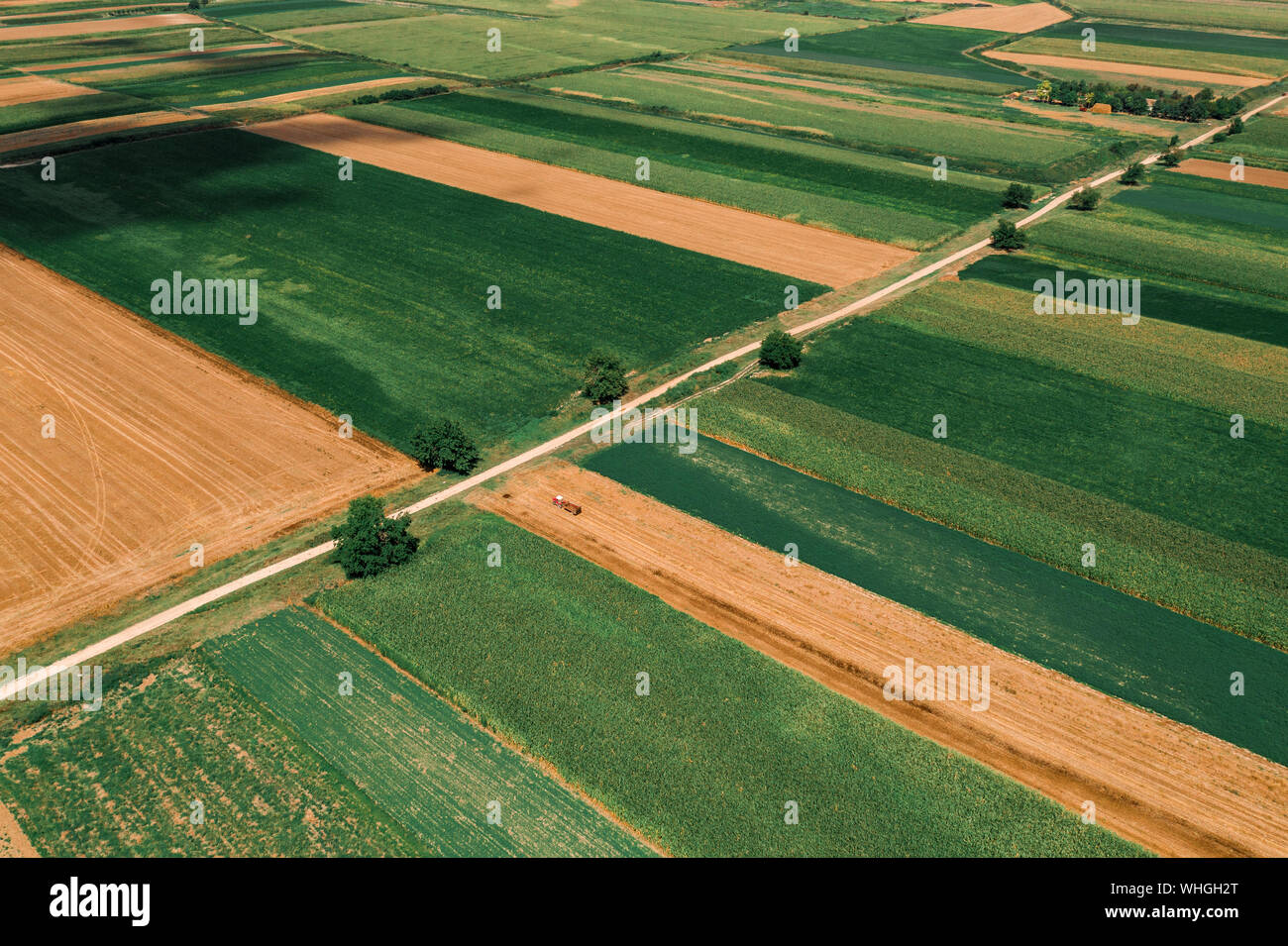 Beautiful countryside patchwork pattern of cultivated landscape from drone pov, fields of corn, soybean and wheat from high angle view Stock Photo