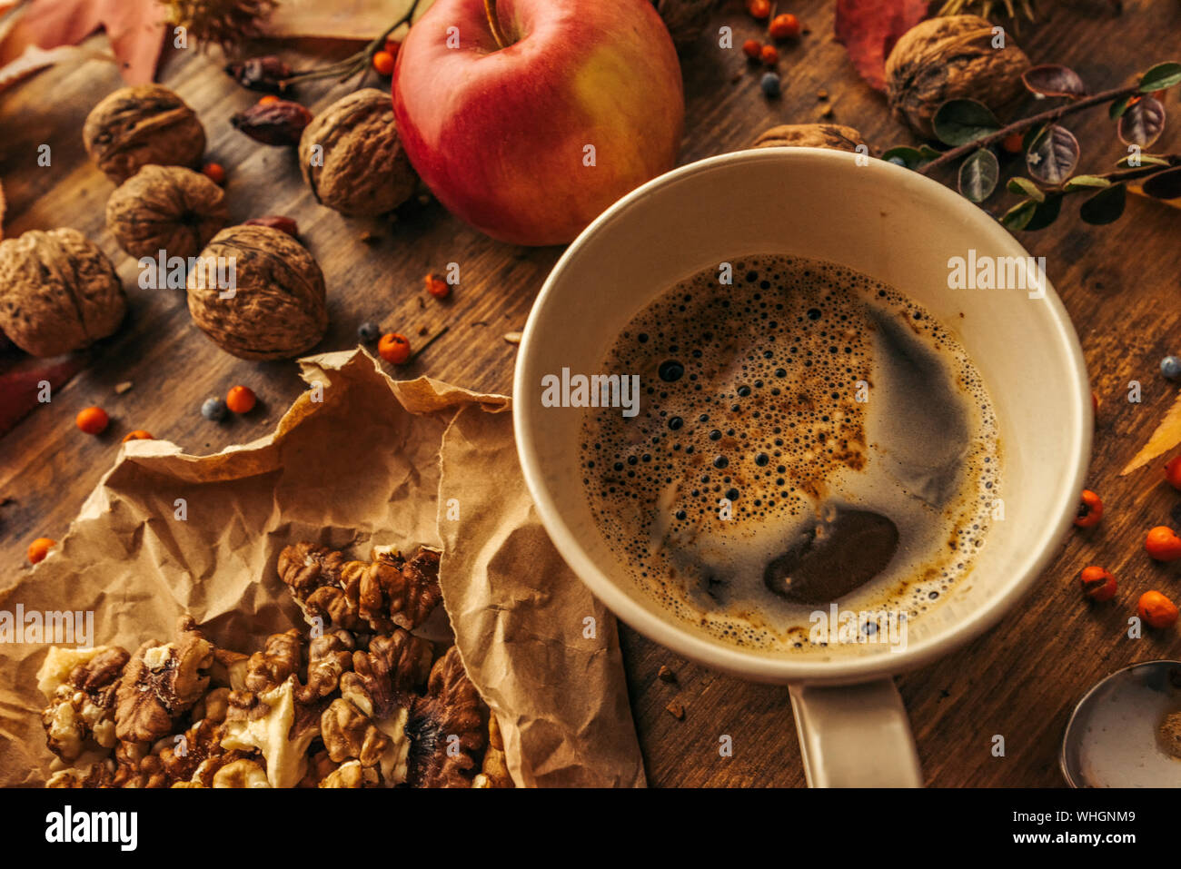 Enjoying fruits of autumn - apple, coffee and walnut on table for Thanksgiving day concept Stock Photo