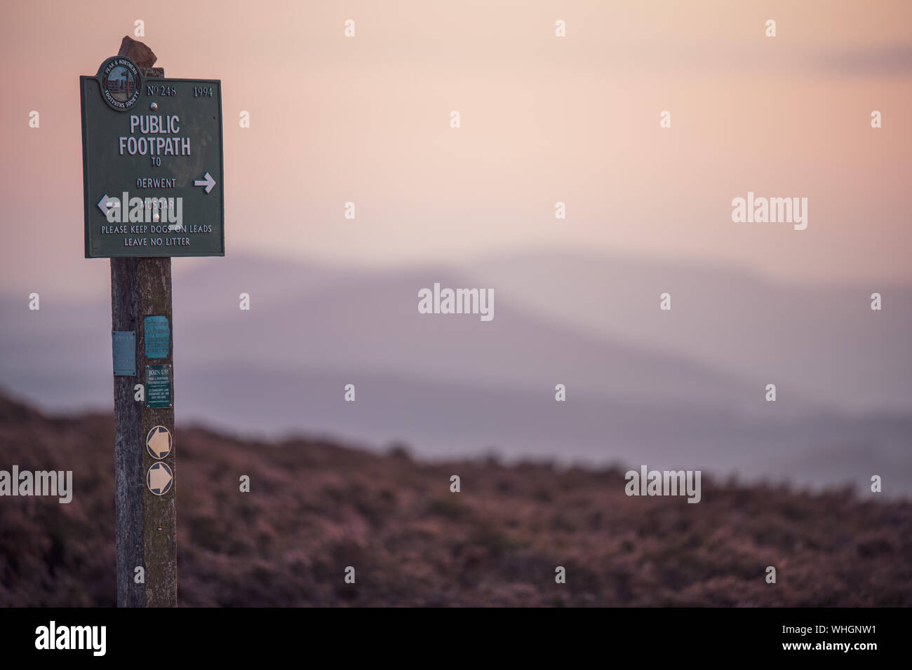 Derbyshire, UK - 26th August 2019: A public Footpath sign taken during a lovely pink sunset in the Peak District National Park Stock Photo