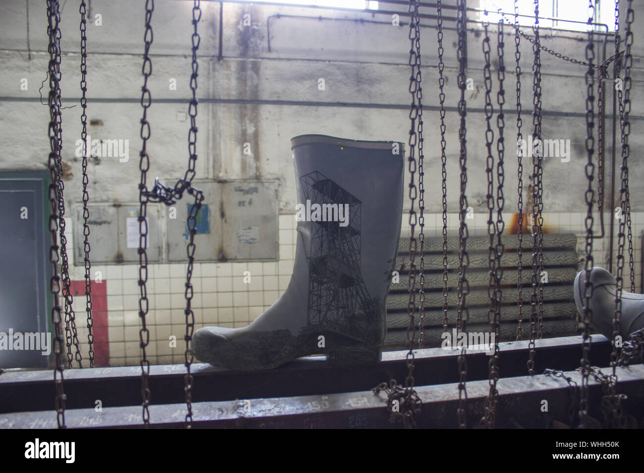 Rubber boots in mining dressing room and chains Stock Photo