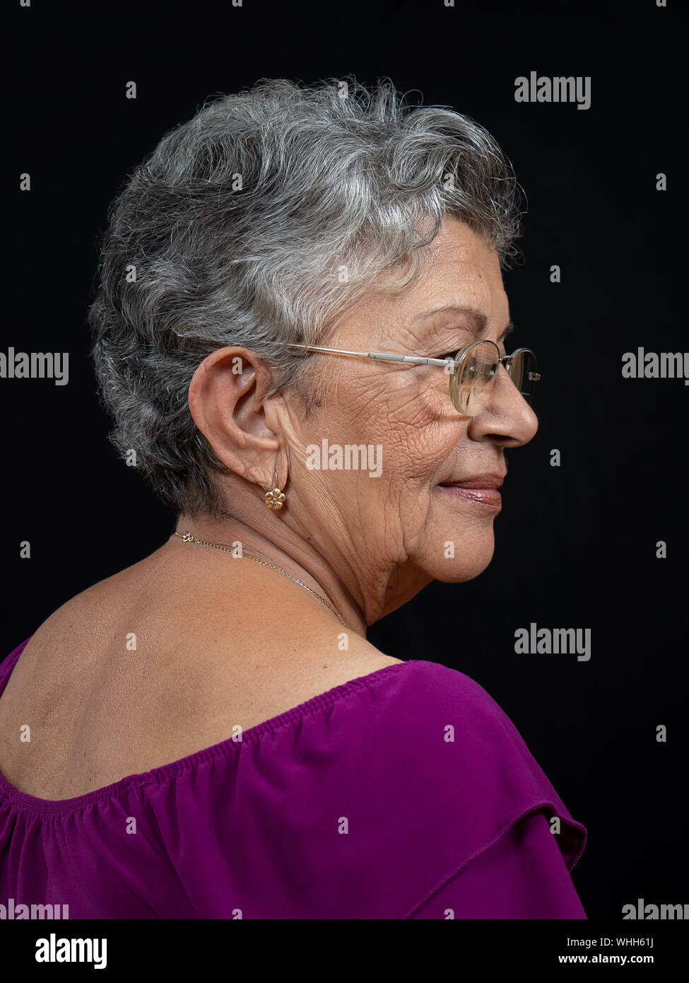 An elderly woman with gray hair wearing glasses Stock Photo - Alamy