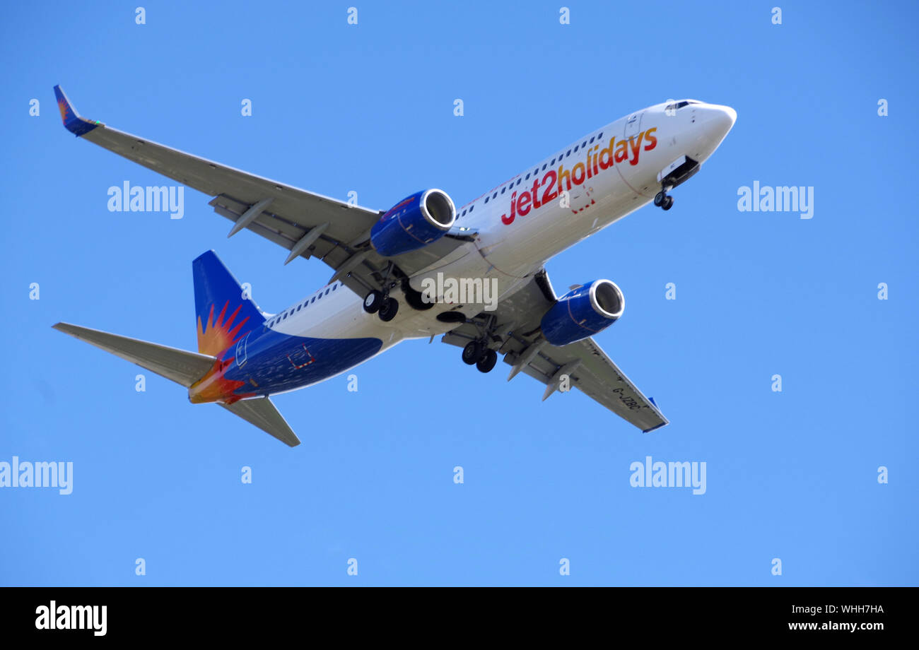 Jet 2 Holiday plane flying over Clydebank preparing to land at Glasgow Airport Stock Photo