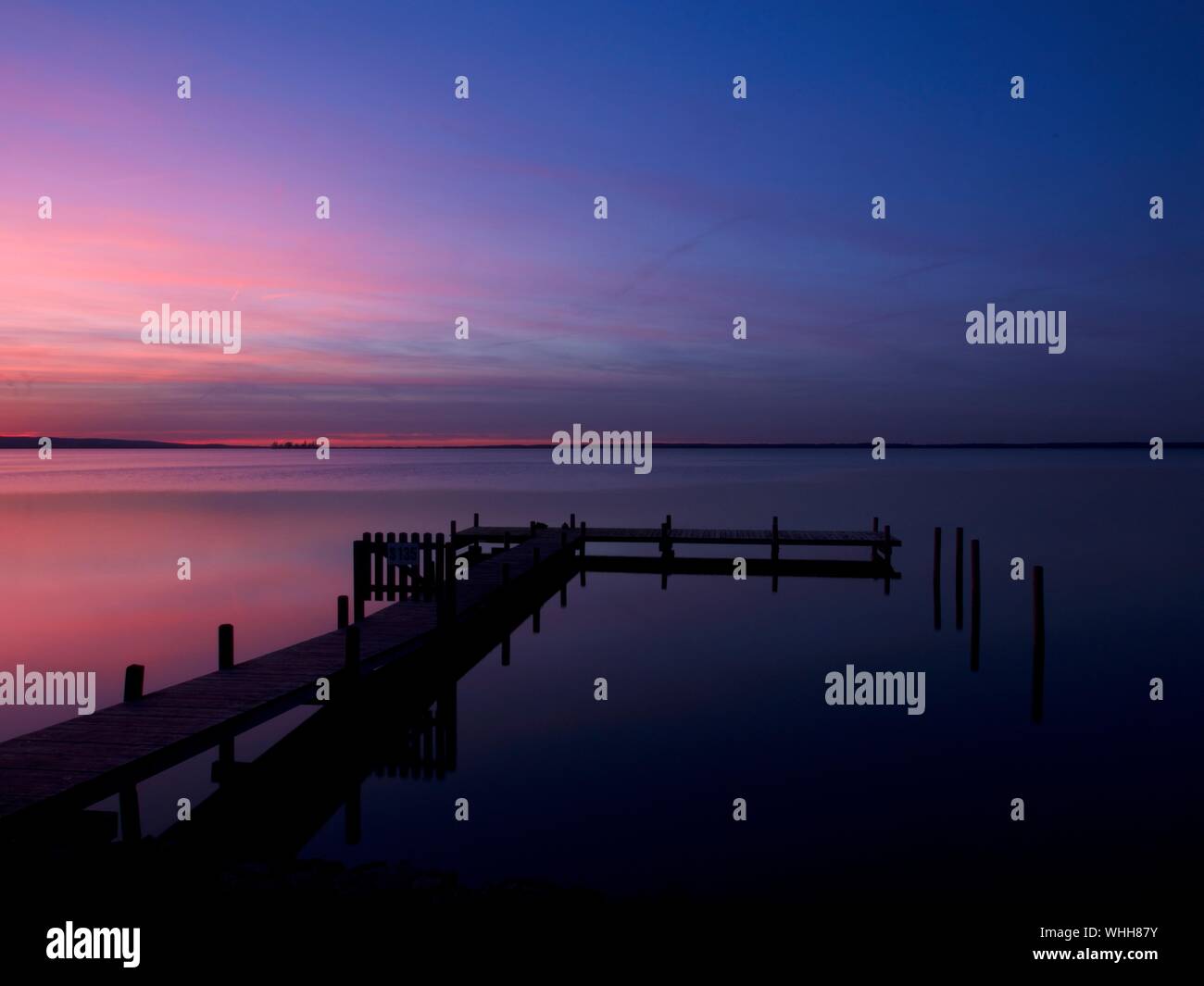 Silhouette Jetty In Steinhuder Meer Against Sky During Sunset Stock Photo