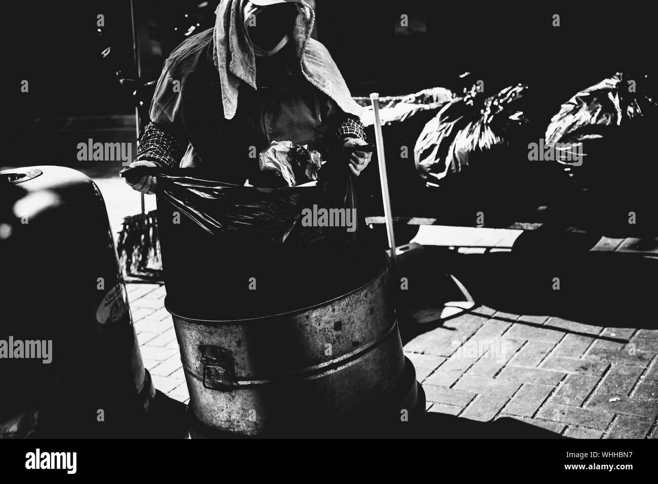 Sanitation Worker Holding Garbage Bag On Street Stock Photo