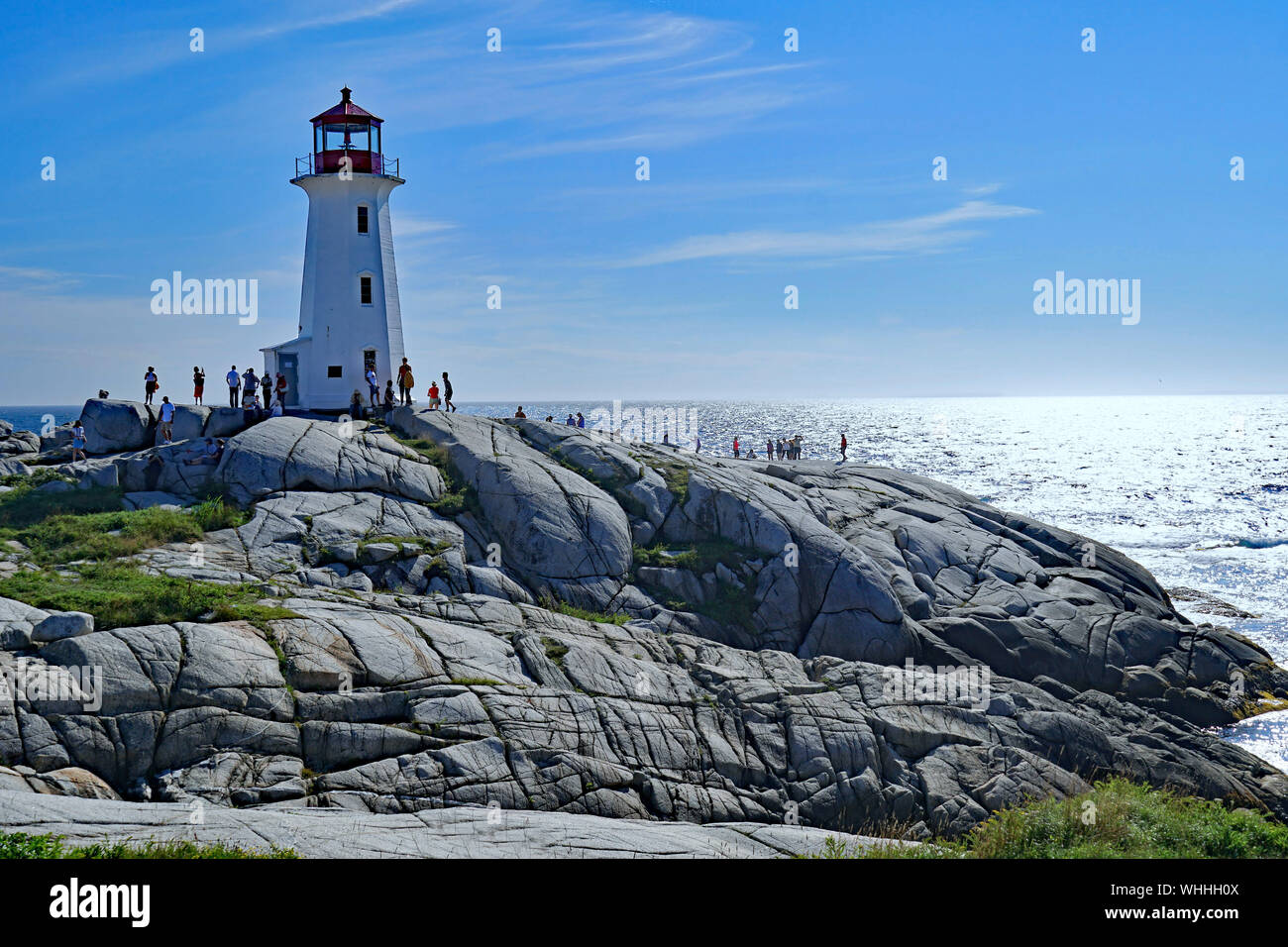 PEGGY'S COVE, NOVA SCOTIA - AUGUST 2019:  The lighthouse and the unique rock formations on which it rests are a popular attraction for visitors on the Stock Photo