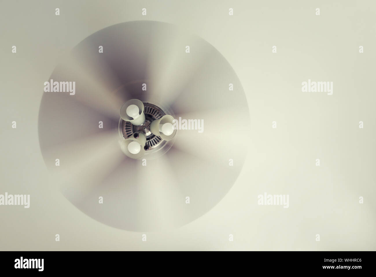 A Working Ceiling Fan On A White Ceiling Close Up With