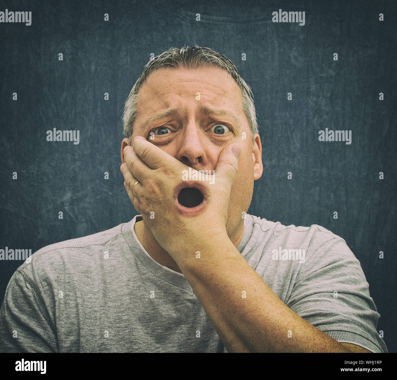 Digital Composite Portrait Of Surprised Man Covering Mouth With Hole In