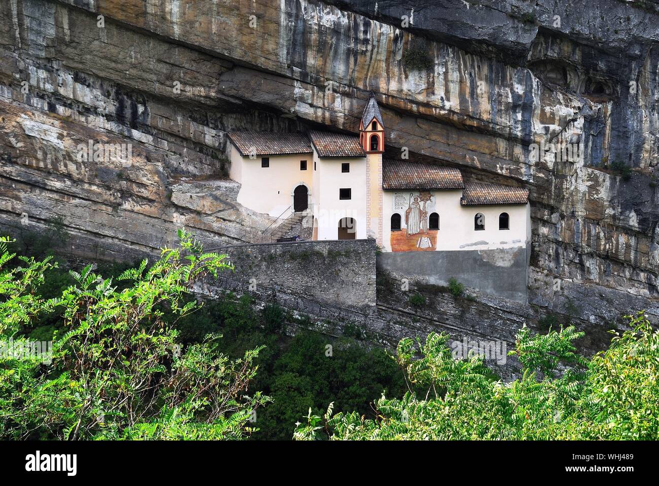 Trentino Alto Adige, Italy. The Eremo di San Colombano is a hermitage in Trambileno,  notable for its location in the side of a mountain. Stock Photo