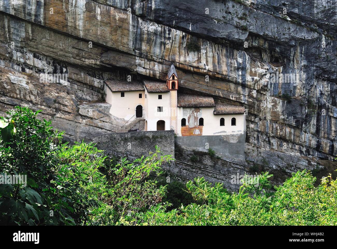 Trentino Alto Adige, Italy. The Eremo di San Colombano is a hermitage in Trambileno,  notable for its location in the side of a mountain. Stock Photo