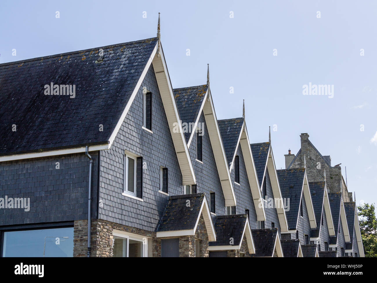 Terraced houses in front of a castle tower. Baltimore Ireland Stock Photo